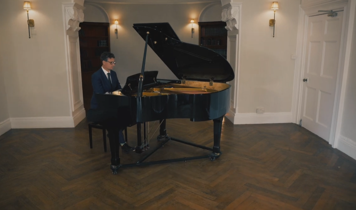 Jamie Crook playing a grand piano at a wedding